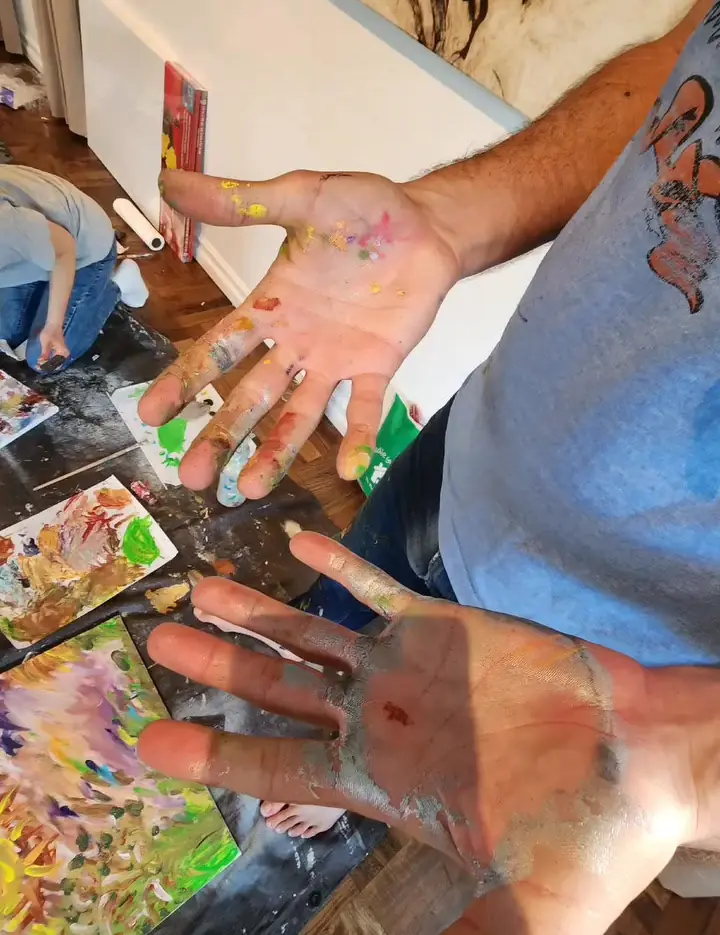 Two hands covered in paint after an art therapy class