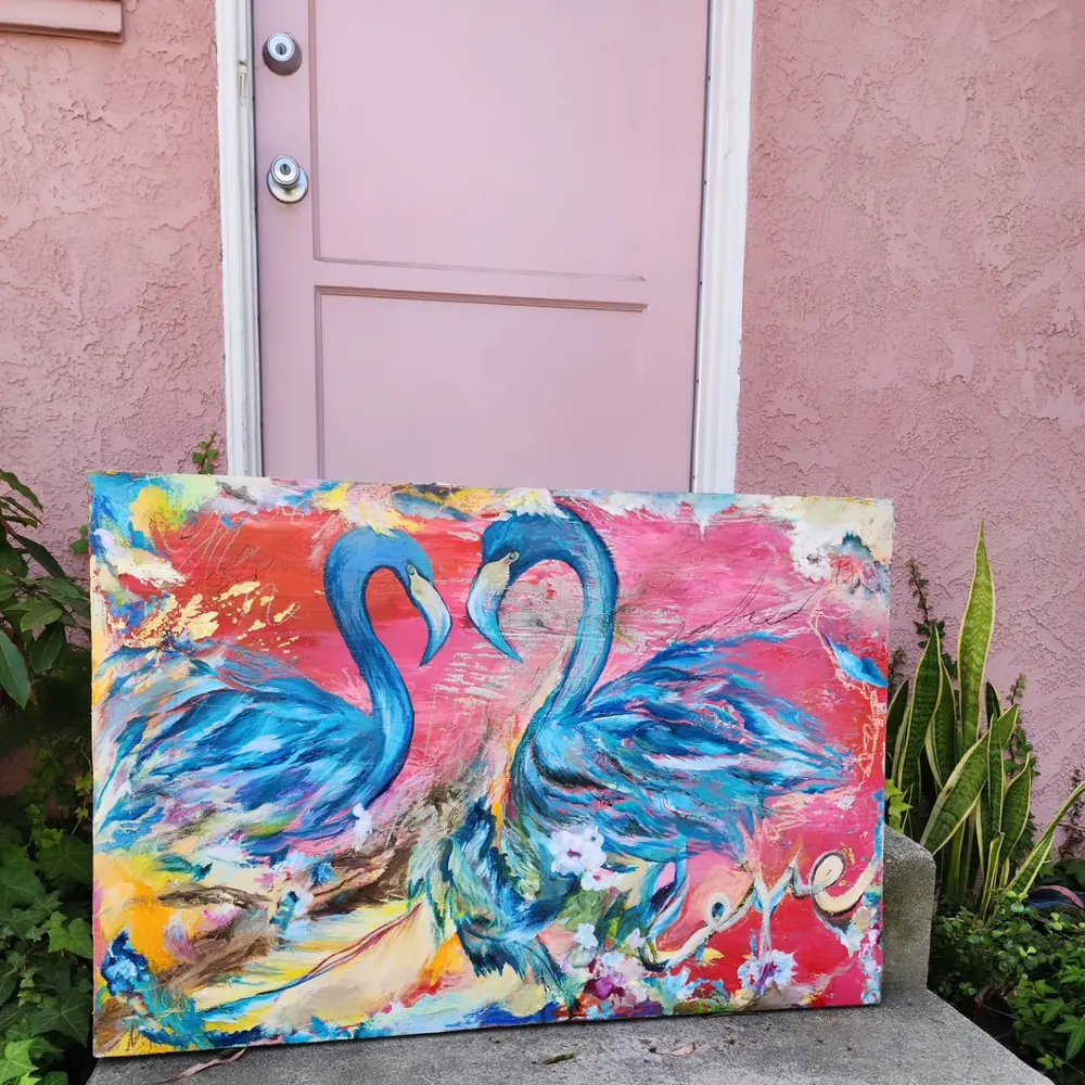 Two blue birds whose necks form a heart over a hot pink background, with the word love